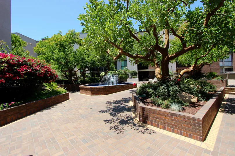 A SUNNY DAY IN THE MARINA PARK WITH TREES, PLANTS, WATER FALL.