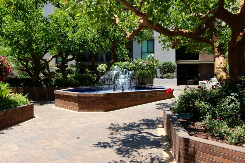 Spouts of water shoot up in a fountain at Marina Park condos
