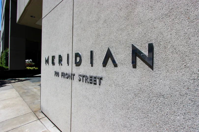 Back sign on a gray residential building at Meridian in Downtown San Diego CA