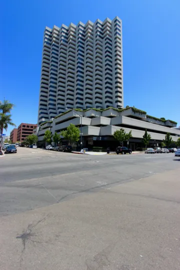 the built is very beautiful and has alot of floors on road has cars and tress in the street