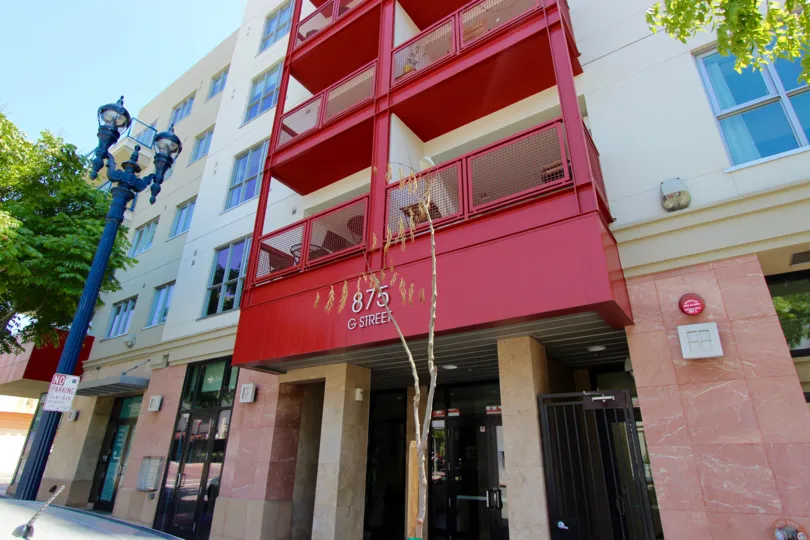 Red metal forms the frame of balconies at Nexus condos.