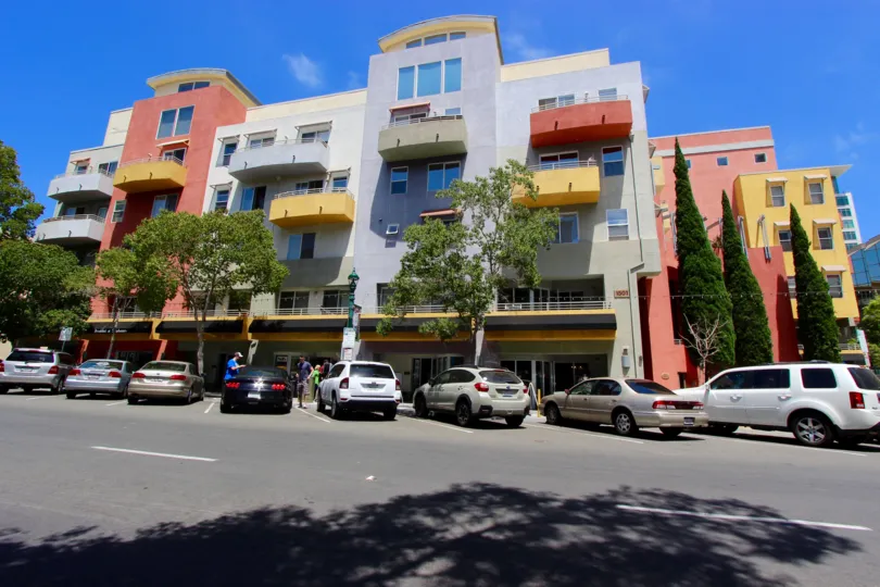 Balconies in red, yellow, and gray sit on a the Palermo building