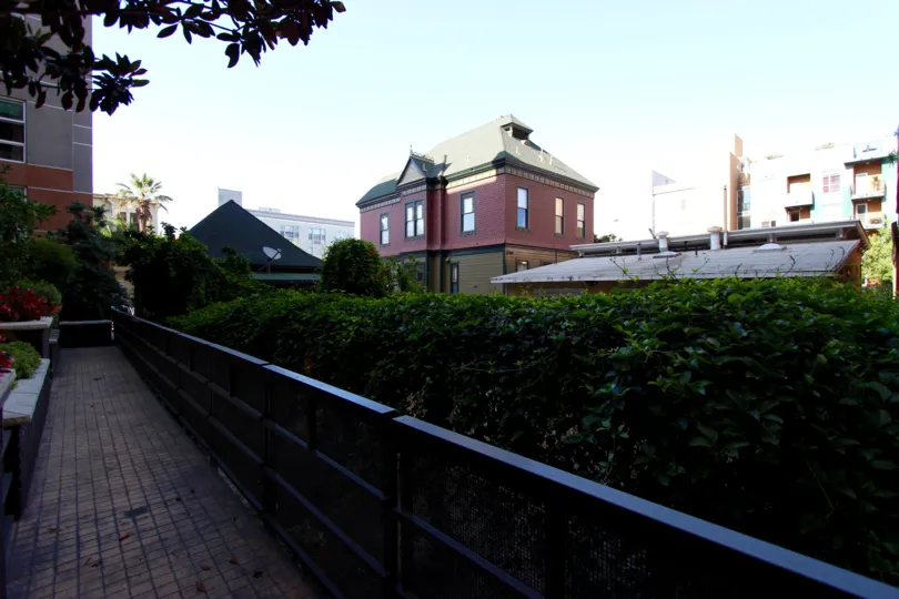 A black fence sits next to a courtyard at Park Blvd East