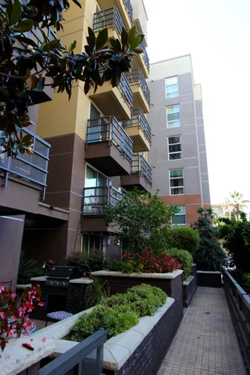 A porch with flower beds and a grill at Park Blvd East in downtown San Diego, CA