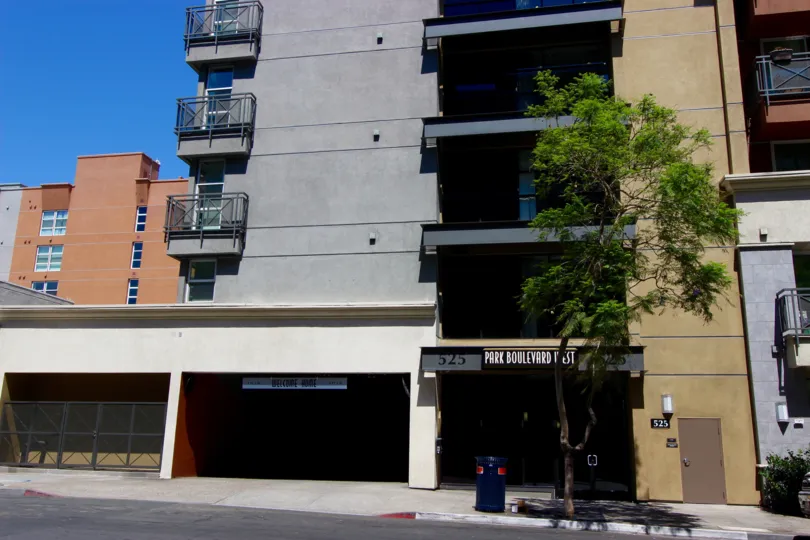 in the sunny day and blue sky, there is a building grey and marron