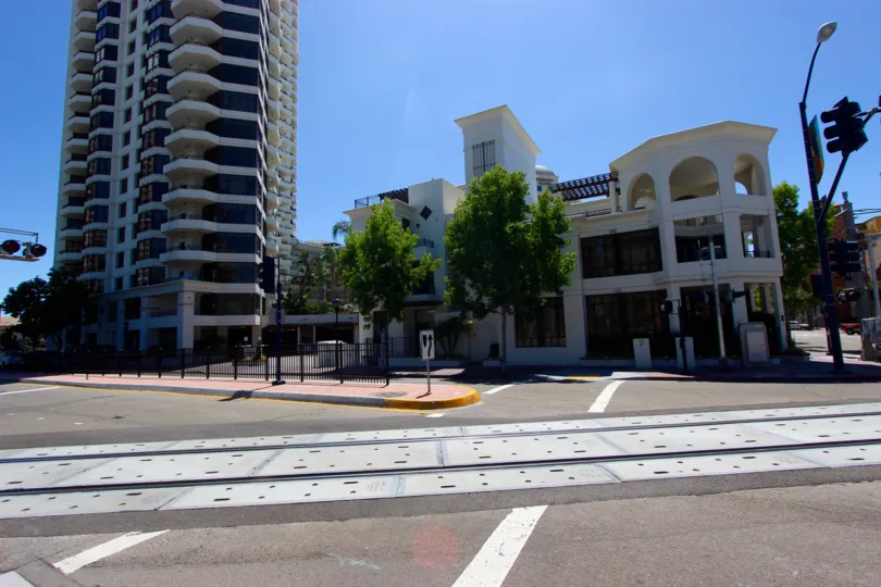 Pedestrian crossing with adjacent railway crossing and wide roadway next to Park Place in Downtown San Diego, CA.