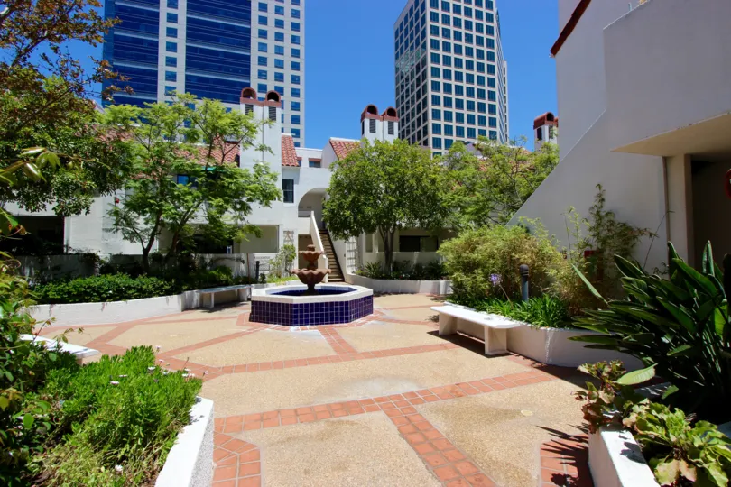 A fountain surrounded by trees in a plaza at Park Row in downtown San Diego, CA
