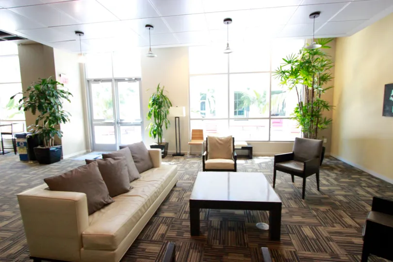 Furniture sitting on a carpeted floor in a lobby at Park Terrace in Downtown San Diego CA