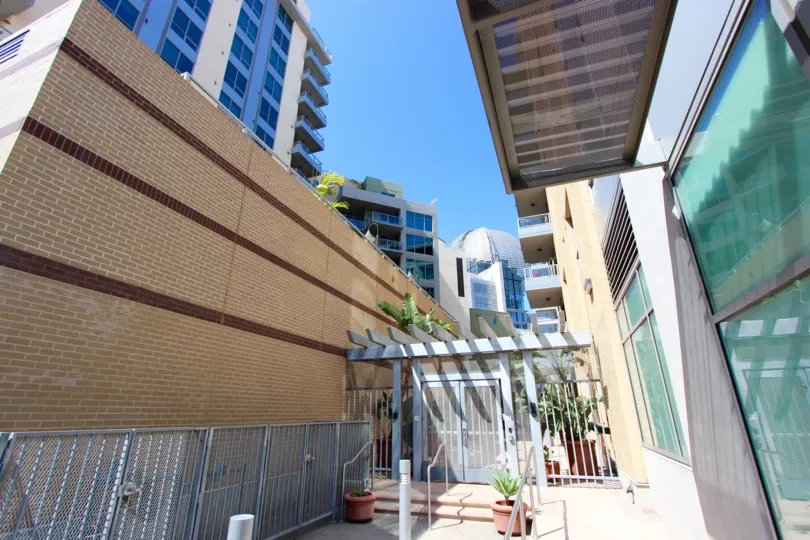 Gray railing mounted to a building next to glass at Park Terrace in Downtown San Diego CA