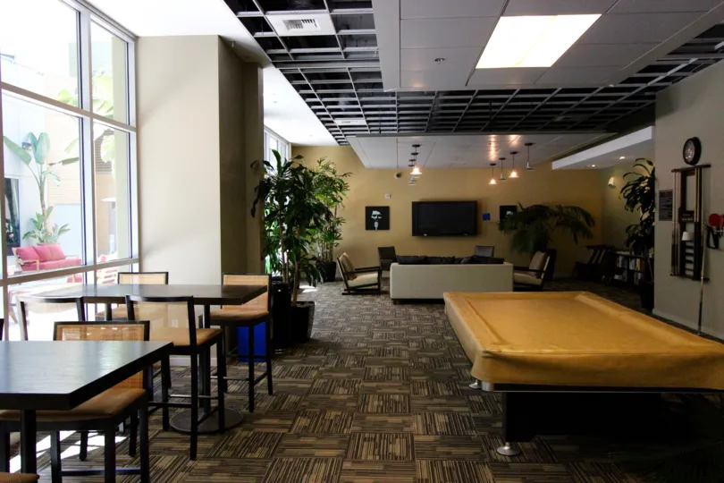 This looks like a Hotel room which has the lot of chairs and tables and also the plants are there in the Park Terrace