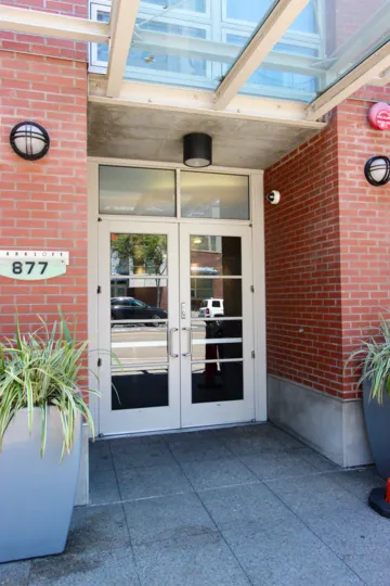 A fire alarm sits on a brick wall at Parkloft condos
