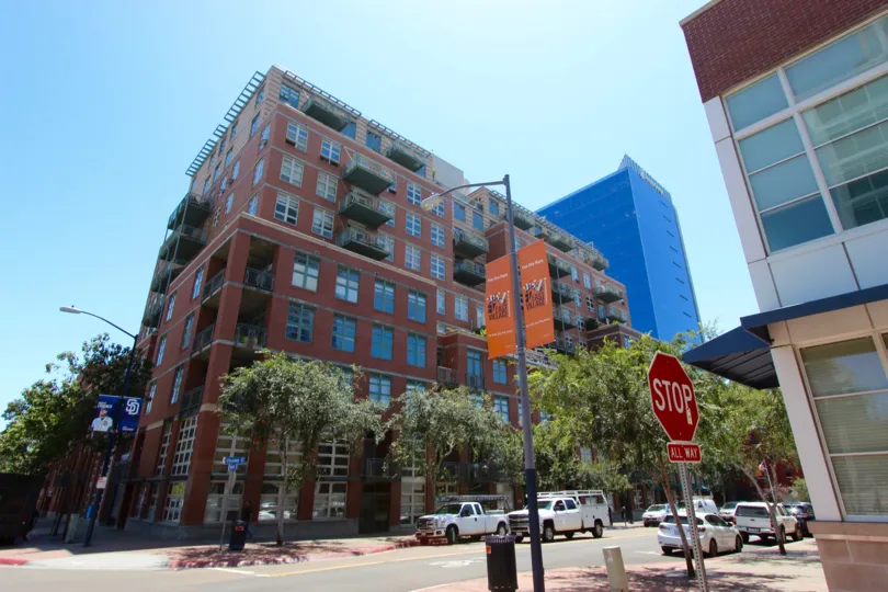 Cars are parked near building and so many trees near building Parkloft