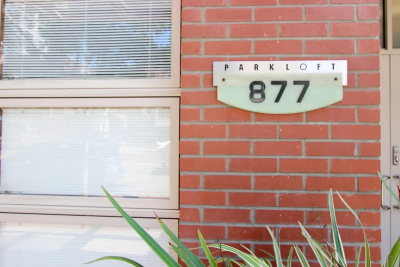 brick wall having name board having number 877 in Parkloft