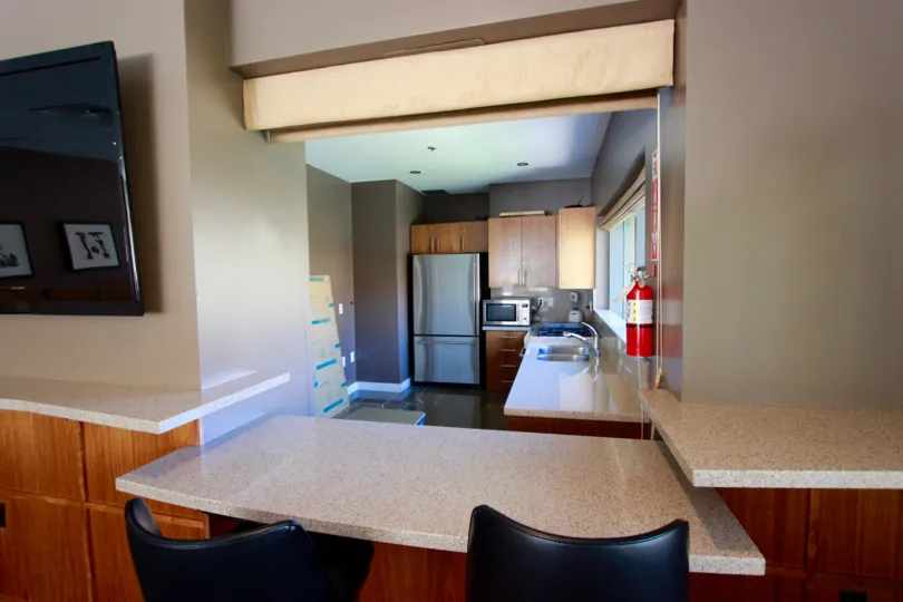 A graceful and inviting view of the modern kitchen at The Pinnace with all modern amenities and a calming simple decor