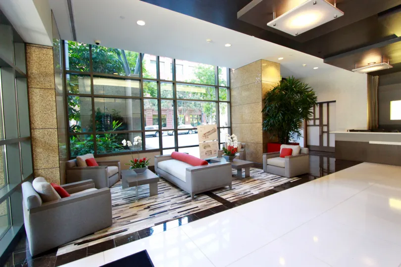 THE HOTEL IN THE PINNACLE WITH WAITING HALL, SOFAS, RECEPTION, TREES.