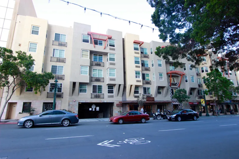 A calm and fine morning at The Portico with exterior views of gorgeous and colorful buildings, shops and parked cars