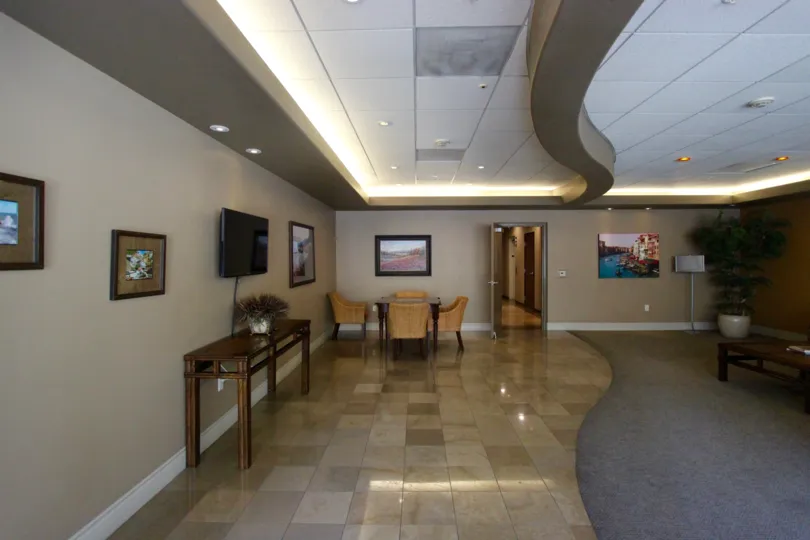 Office area with tv, chairs and tables in the Porto Siena community