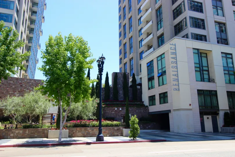 A sunny day in the area of Renaissance, outside, condo, tree, light pole, sidewalk, street