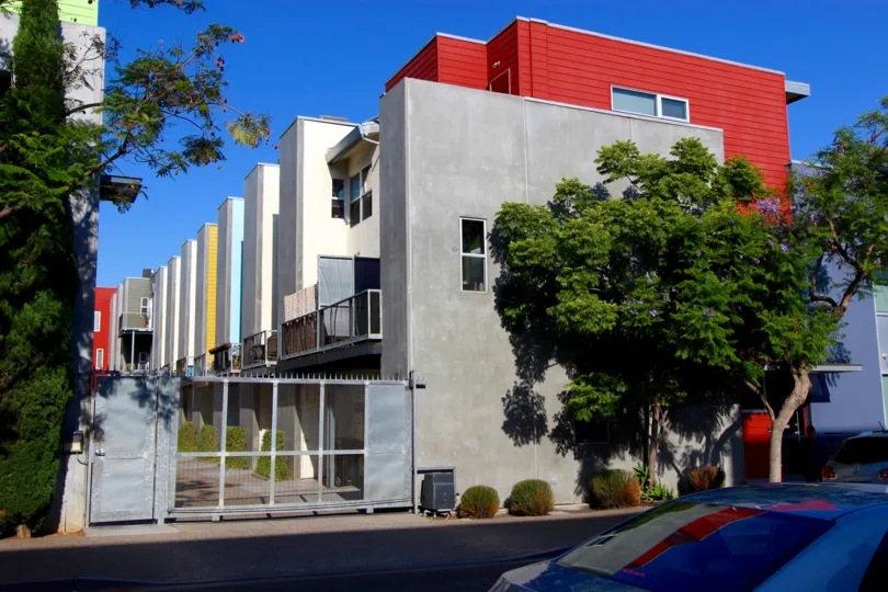 A beautiful day in downtown San Diego, displaying a gated building with trees in front