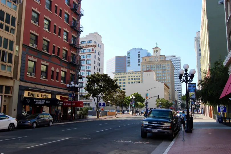 A sunny day in the area of Rowhomes on F, street, truck, car, tree. cityscape, bar, restaurants