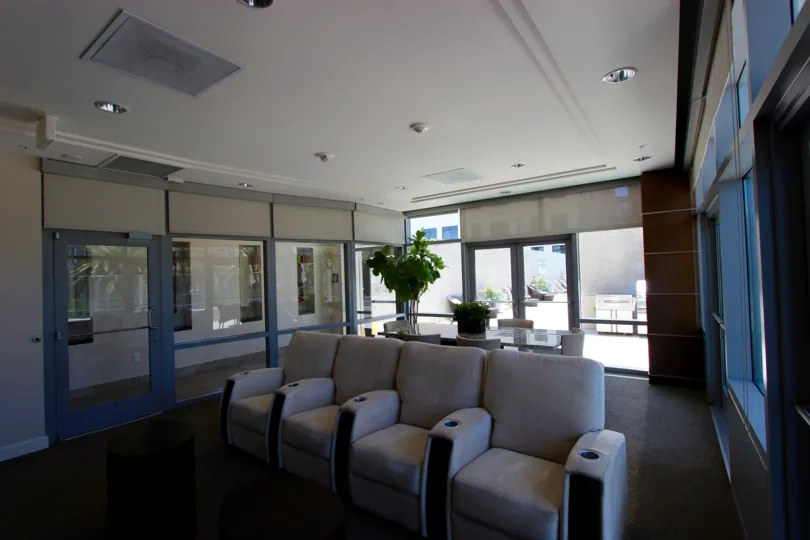 Four reclining chairs sits side by side in a community area at Sapphire Tower