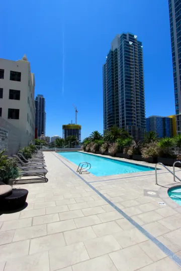 A skyscraper near a water pool with blue color everywhere at Sapphire Tower