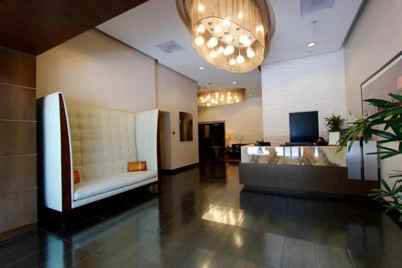 A sunny day in the area of Sapphire Tower, chandelier, desk, couch, lobby