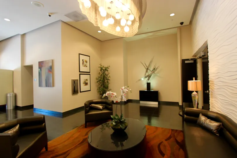 Awesome decorated main hall with sofa in photo frame lights and plants in Sapphire Tower