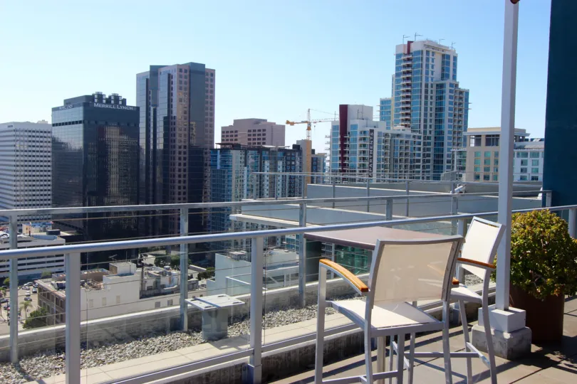 A sunny day in the area of Smart Corner, rooftop, chair, city view, potted plant, stone