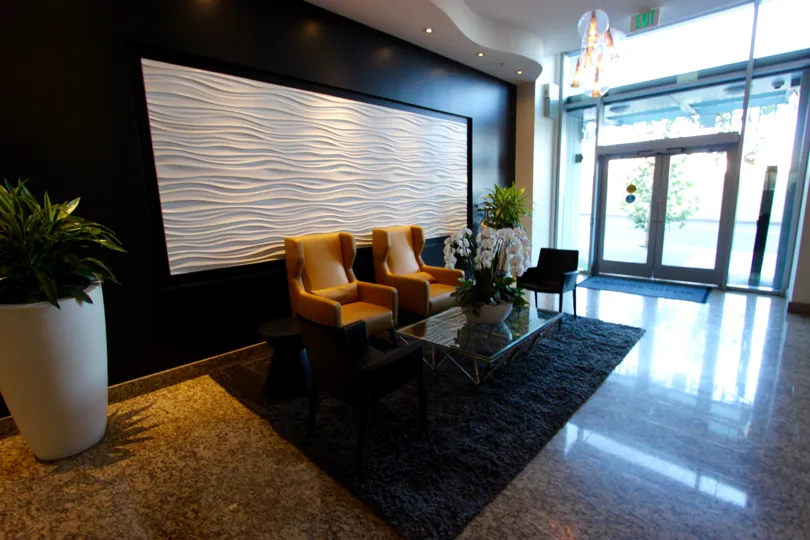 A wavy white piece of art sits on the wall in the lobby of the Smart Corner condos.