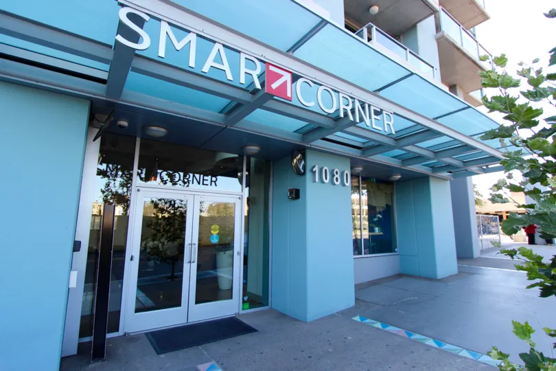 Light blue color walls and glass door entrance in Smart Corner.