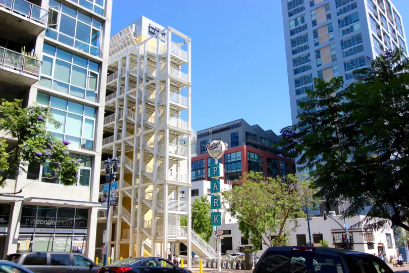 a view of Smart Corner showing the exterior of downtown buildings and a parking lot.