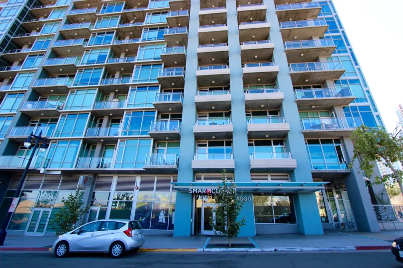 Front entrance of Smart Corner high rise apartments on a sunny day.
