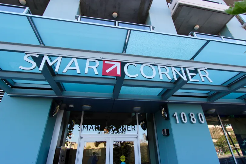 A sign entering a building that is showing the community Smart Corner