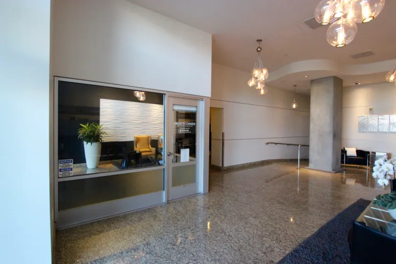 A sunny day in the area of Smart Corner, inside, lobby, desk, potted plant, chair, door