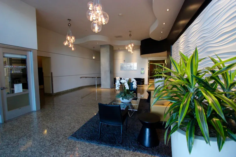 The Smart Corner Condos front lobby with chairs and table and plants in downtown San Diego