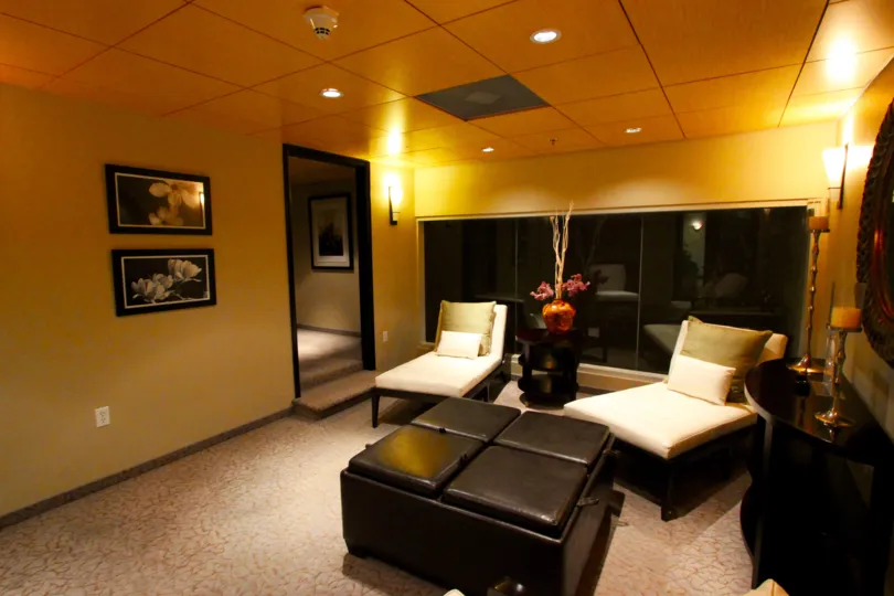 Hall decorated in gold color paint with sofa, furniture and photo frames in the building in Solara Lofts