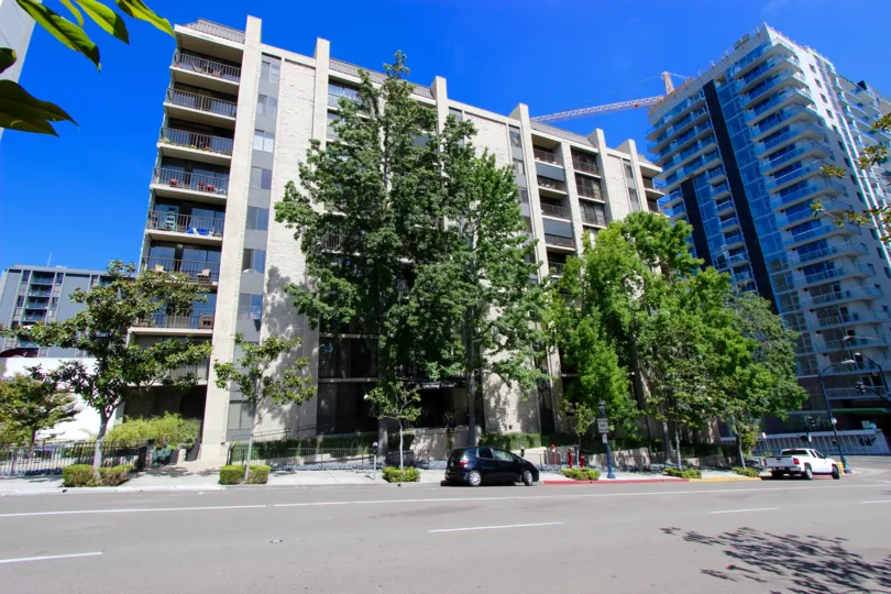 The tree covered entrance of the Symphony Terrace on a sunny day in downtown San Diego, Ca.