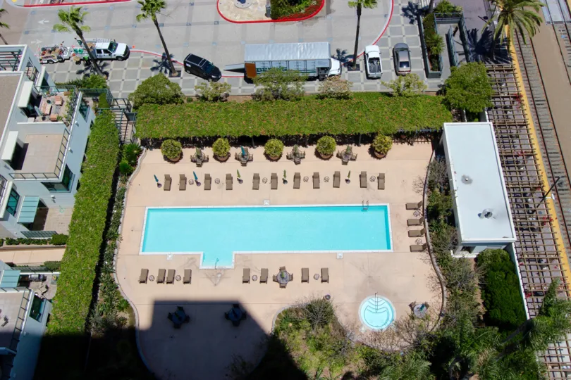 Beautiful sunny view overlooking the pool with patio tables at The Grande.