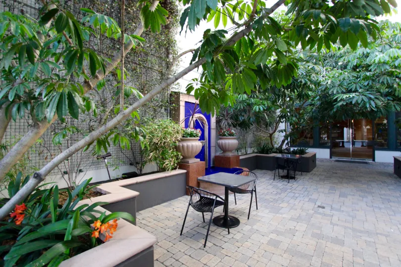 Bulding have a beautiful front view with trees and plants with portico in The Legend