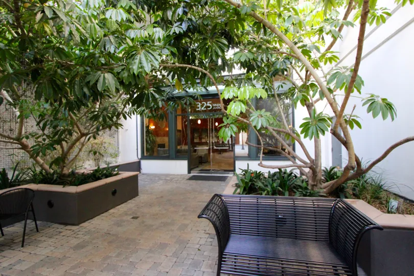 A courtyard with chairs and ornamental plants at The Legend downtown San Diego CA