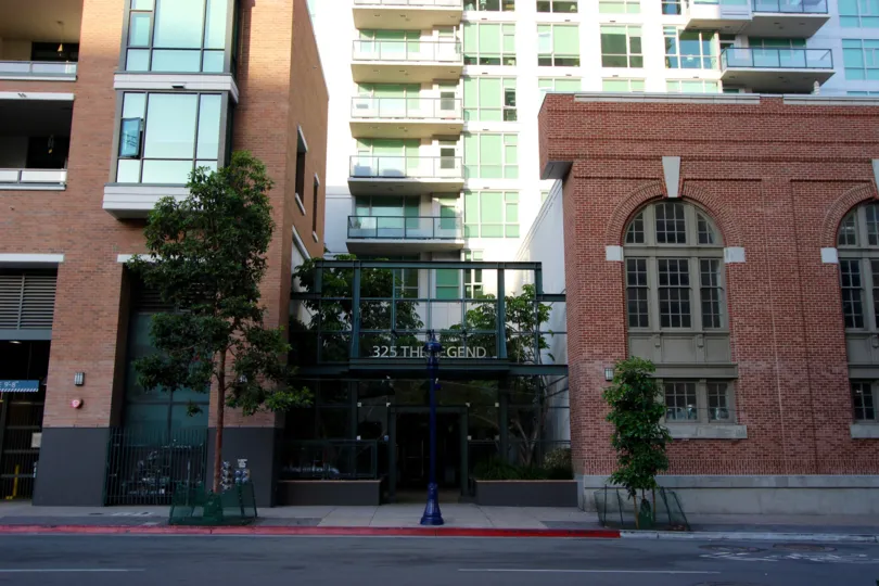 Tall red brick buildings outside of The Legend in Downtown SD CA.