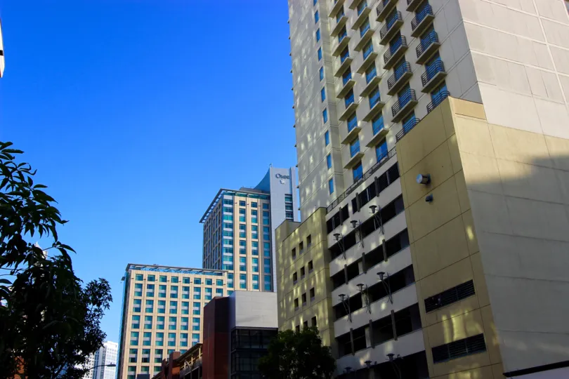 This high-rise shadows the trees below it on a sunny day in San Diego