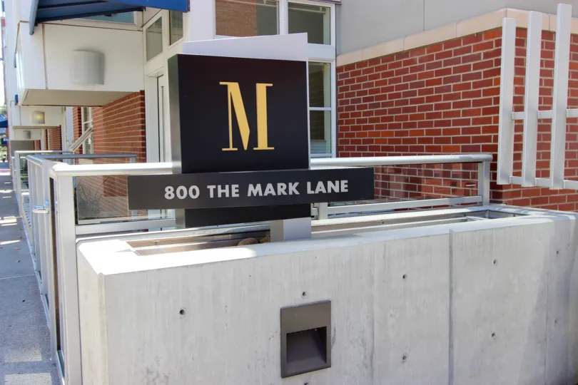 a black coloured sign that tell the location of mark street