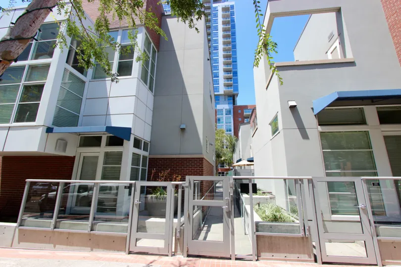Glass panels in a silver frame half wall sits at the entrance to The Mark condos