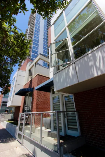 A sunny day in Downtown San Diego California with an open window of a building and a high rise in the background