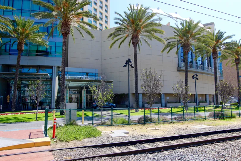 A huge building with palm trees in front of that in The Metropolitan.
