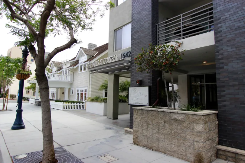 A sunny day in the area of The Mills at Cortez Hill, entrance, window, trees, sidewalk