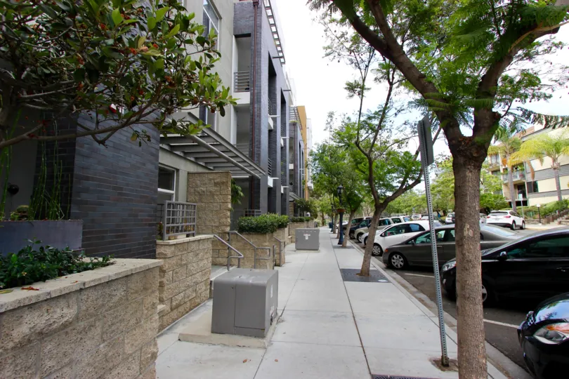 Sidewalk between buildings and parking spaces in The Mills at Cortez Hill, in Downtown San Diego, California.