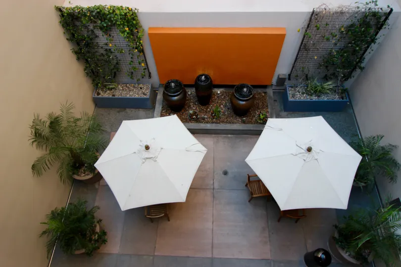 A backyards view with a picnic table and a little garden in Trellis, San Diego
